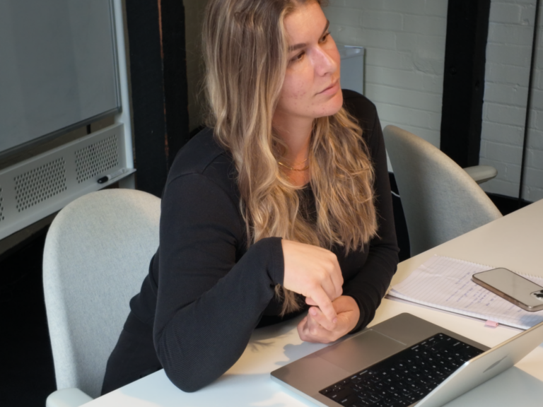 Double H Marketing team member in meeting with laptop